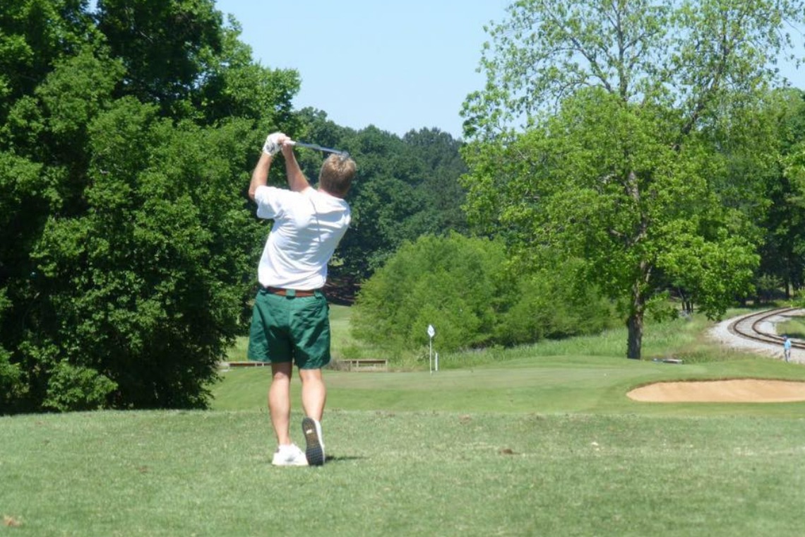 golfer taking a swing on the green